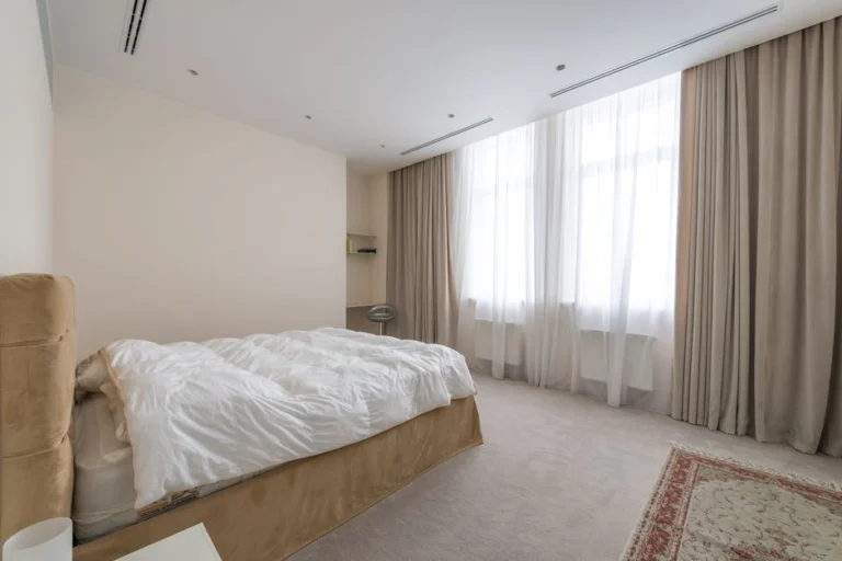 Bedroom with light carpet